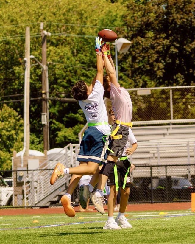 Two ALL HEART players leaping for a catch